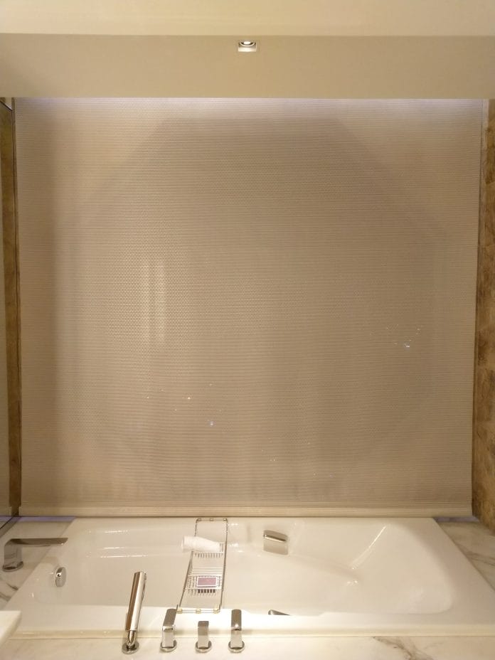 Blinds beside the bath tub