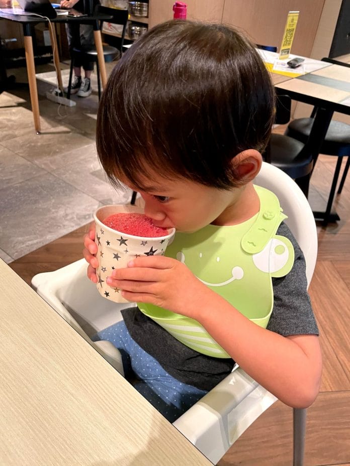 Toddler drinks watermelon juice